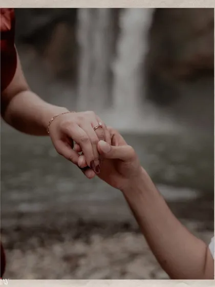 A detailed shot focusing on their hands and the new ring. This simple image speaks volumes about their new journey together, with the natural backdrop hinting at their adventurous spirit.