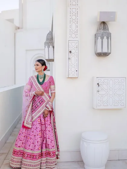 A full view of this graceful and culturally rich look. The makeup was kept refined and minimal to complement the vibrant colors and patterns of her traditional attire.