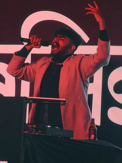 Singing along with the crowd, completely lost in the performance. This is pure passion.
