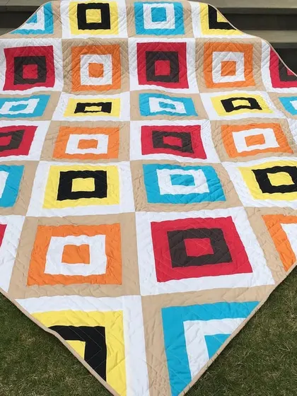 Another view of the colorful "square in a square" quilt.