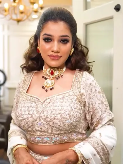 This look was for a reception or cocktail party. I created a dramatic dark smokey eye, balanced with a soft nude lip. The voluminous, wavy hair adds a touch of modern glamour.