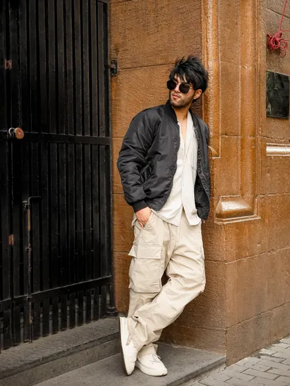 A relaxed pose against the wall, showing a different mood.