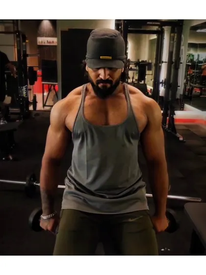 FOCUS. A moment of concentration before starting a set of dumbbell lateral raises for shoulder width.