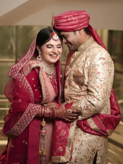A moment of shared laughter and pure happiness. This candid shot captures the couple's joy and comfort with each other on their wedding day.