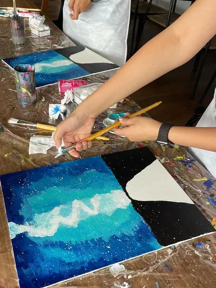 A close-up of a couple's painting in progress. The process is just as important as the final product, and we make sure it's a fun and relaxing one.