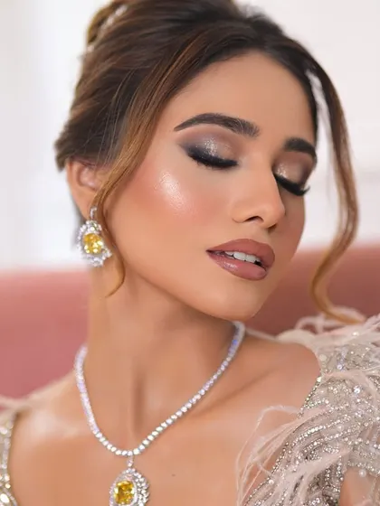 A classic smokey eye paired with a shimmering silver and feather gown. This is the ultimate glam look for a cocktail party or reception.