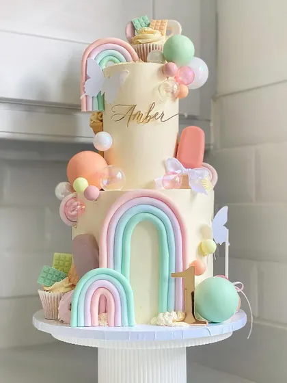 Another angle of the pastel rainbow first birthday cake.