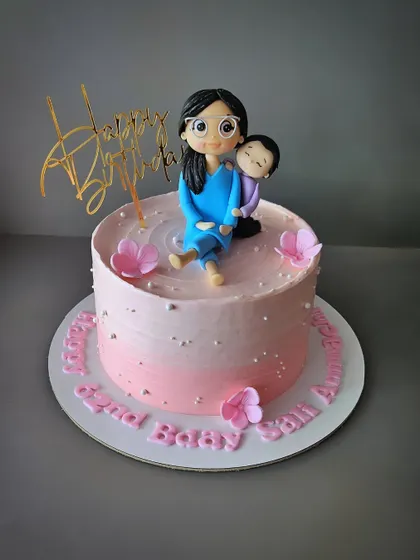 That beautiful bond between a Grandma and Grandson. A chocolate truffle cake with a custom figurine capturing a precious moment.