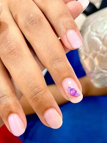 The hottest minimal butterfly nails. A single, delicate purple butterfly adds a touch of magic to this clean and simple manicure.