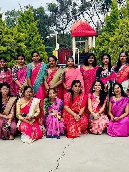 Our wonderful team of teachers, all dressed in pink, poses for a group photo, showcasing the strong bond they share.