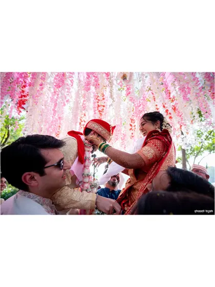 The 'varmala' or garland exchange, often a playful moment as friends lift the bride and groom.