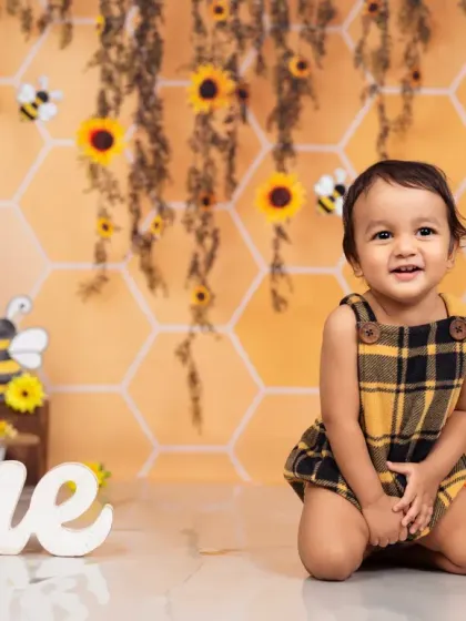 What will it bee? A happy little one enjoying our honeybee-themed first birthday setup.