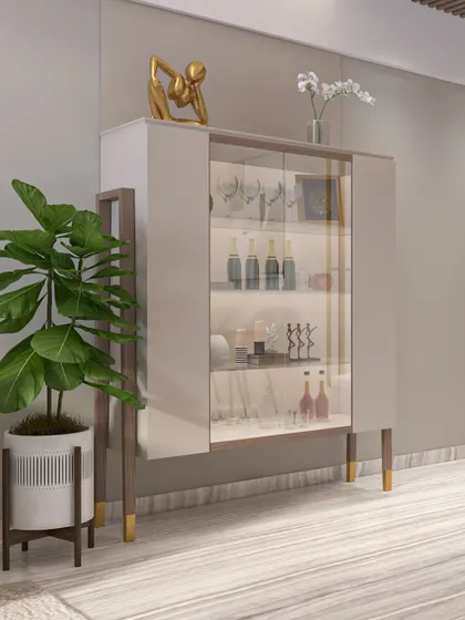 A sophisticated, freestanding bar cabinet with glass doors, internal lighting, and elegant gold-finish legs. It's a piece of furniture that is both functional and beautiful.