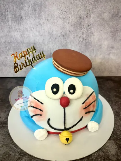 Hello, Doraemon! This cute 3D cake is made with whipped cream and features Doraemon's happy face, complete with his bell and a Dorayaki on his head.