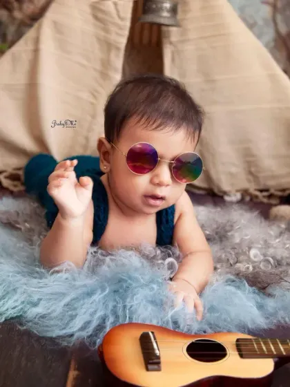 The coolest little rockstar in town, complete with sunglasses. This shot is full of personality and shows the fun side of our themed baby photoshoots.