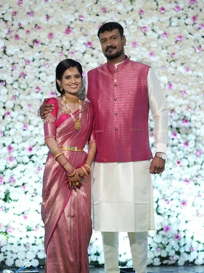 The couple looks so elegant in their coordinated pink and white outfits.
