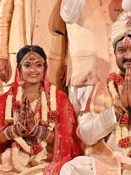 A happy couple, Madhura and her groom, during their wedding ceremony. Her dark mehendi stain is a beautiful part of her bridal look.