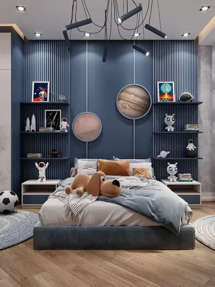 An outer-space-themed bedroom perfect for a budding astronaut. We used a deep blue accent wall, planet-themed decor, and open shelving to display space-related toys and models.