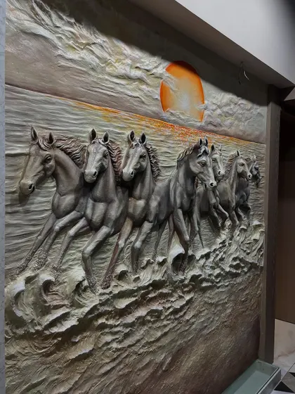 An angled view showing the depth and texture of the dark 7 horses mural. The sculpted waves and muscular definition of the horses are clearly visible.