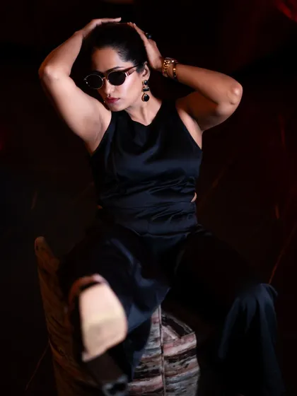 An artistic, low-light shot from the same session. The dramatic shadows and pose create a high-fashion feel, elevating the content.