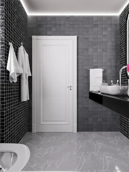 This view shows the floating vanity and sleek black countertop, contrasting with the white door in this contemporary bathroom.