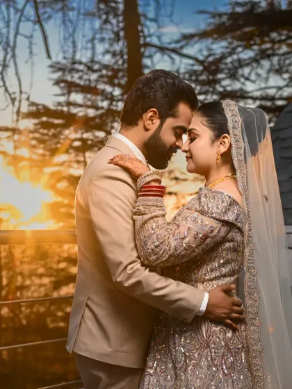 An intimate embrace at sunset, with the warm golden light washing over the couple. This shot is full of warmth, love, and the promise of a beautiful future.