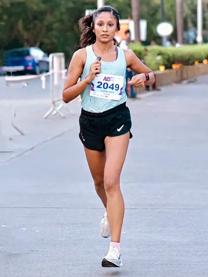 Mind of a hustler, heart of a queen. In the zone during a 10k race, focused on speed and performance.