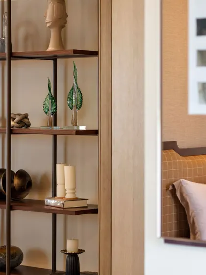 Curated shelving is an opportunity for storytelling. Here, glass leaf sculptures, books, and other objects are carefully arranged to create a composition that is both decorative and personal.