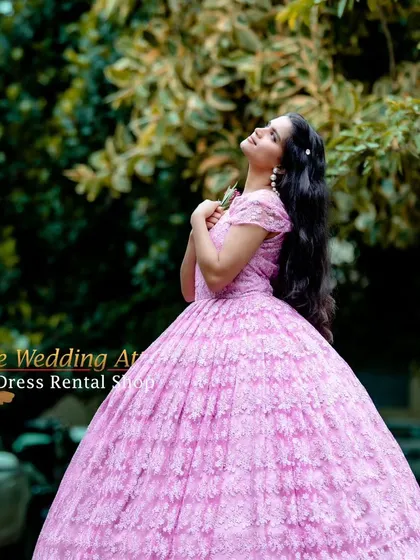 This pose in the pink lace ball gown creates a sense of romance and longing, perfect for storytelling in your photos.