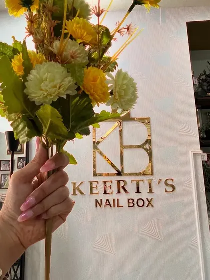 A shot of the pink ombre nails against the Keerti's Nail Box logo. This design is a client favorite.