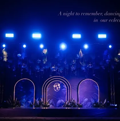 For a Sangeet night that’s all about glamour and rhythm, we designed this eclectic stage with dramatic blue lighting and modern arches. It set the perfect mood for an evening of dance battles, dhol beats, and non-stop celebration.