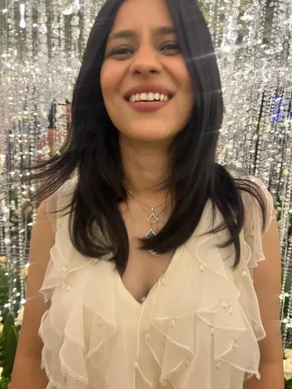 A happy close-up from the sangeet night. The delicate pearl detailing on the ruffled neckline of my jumpsuit added a touch of glamour, paired with a simple layered necklace.