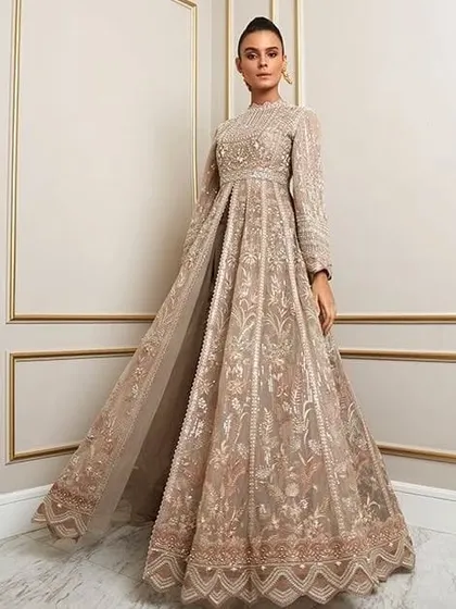 This high-neck, full-sleeved gown with a front slit offers a modern and regal look. The detailed embroidery is consistent from top to bottom.