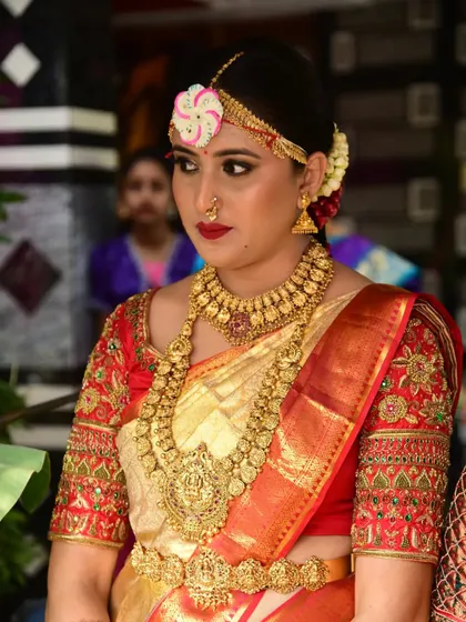A close-up of the bride's muhurtham look, featuring a classic temple jewellery set with a Lakshmi pendant.