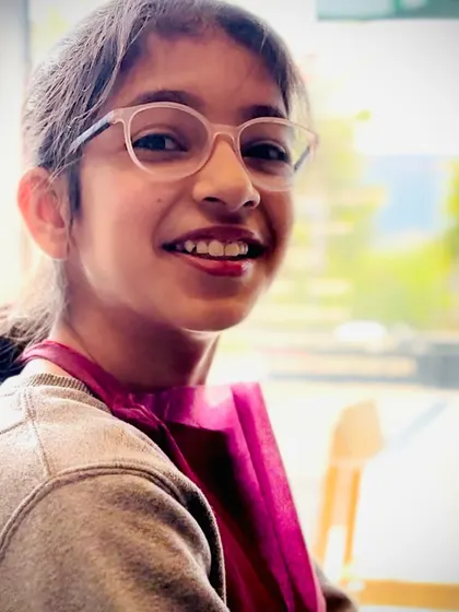 A young artist smiling brightly during our bougainvillea workshop. We welcome painters of all ages and skill levels.