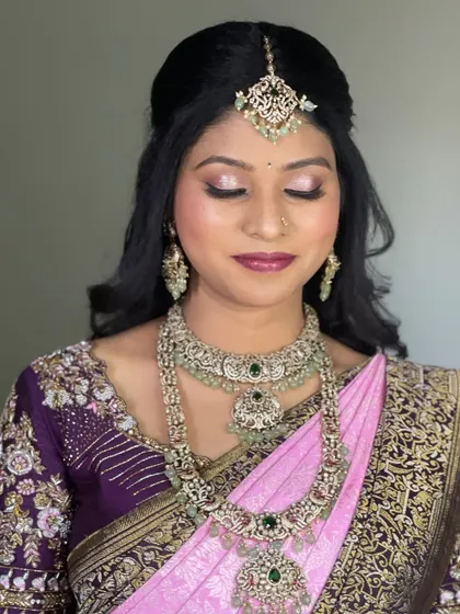 A detailed shot of the eye makeup for Pavitra's reception look. The soft shimmer and defined liner make her eyes pop, perfect for an evening event.