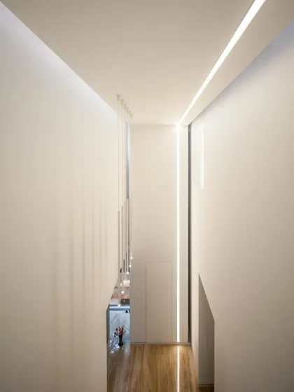 skylights and linear lighting combine to define the vertical circulation core of the home.