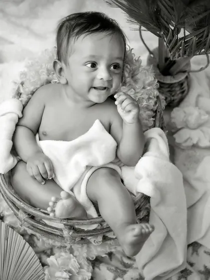 A timeless smile. This simple, happy portrait of an older baby is transformed into a classic piece of art in black and white.