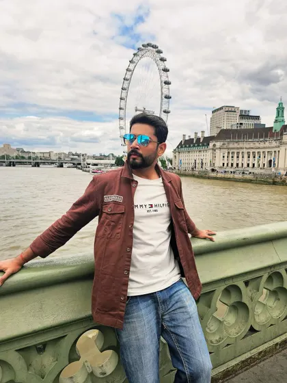Posing with the London Eye in the background. This image combines a casual outfit with an iconic landmark, showcasing my potential for international travel and tourism promotions.