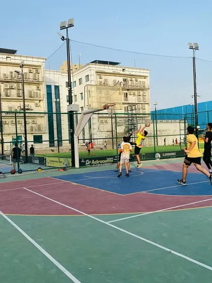 A player attempts a layup while others position for the rebound.