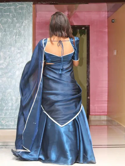 The back view of the Langa Dhawani, showing the tie-up detail of the blouse and the elegant drape.