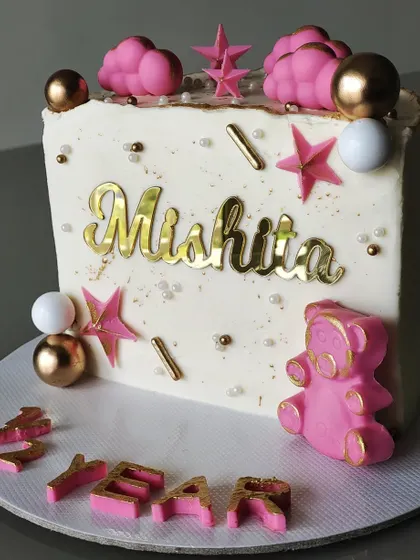 Another adorable half-year birthday cake. This design features a clean white canvas decorated with pink stars, clouds, and a cute teddy bear, with the words "Half Year" spelled out at the base.