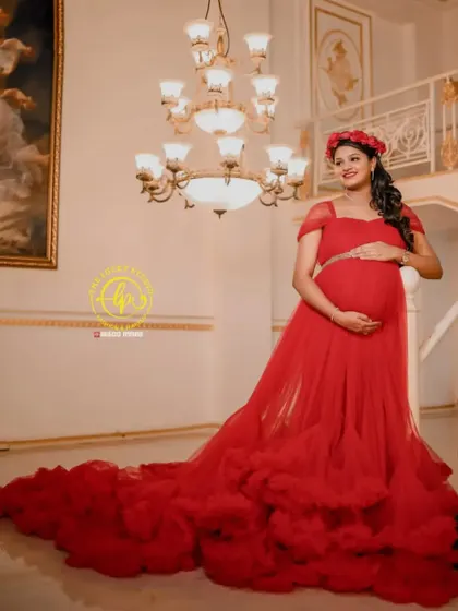 A regal maternity look. I styled this client in a magnificent red tiered gown and a floral crown, creating a glamorous and powerful portrait in this grand hall.