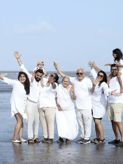 We specialize in capturing the entire 'khandaan'. This outdoor beach session shows a multi-generational family portrait, ensuring that grandparents, parents, and children all share in a beautiful, coordinated memory.