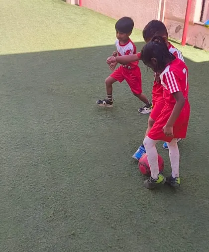 A young footballer practices her dribbling skills during a drill. We create an inclusive environment where girls are encouraged to participate, build confidence, and develop a passion for the sport.