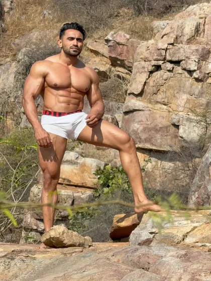 A confident pose, showing the leg and ab definition.