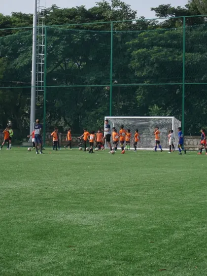 Young players in our U12 and U14 trials participate in a drill near the goal, learning positioning and movement.