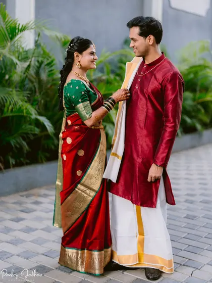 A playful moment as the bride adjusts the groom's attire during their couple portraits.