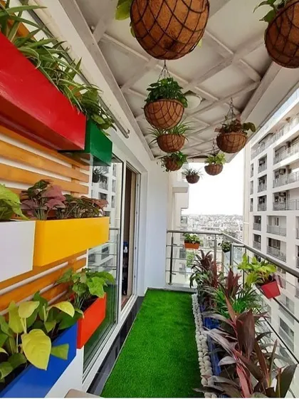 Color can completely change a space. We used a variety of vibrant planters, both on the wall and hanging from the ceiling, to turn this high-rise balcony into a cheerful and dynamic garden with a stunning city view.