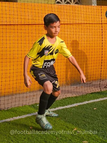 A player shows agility and focus during a training drill. The shadows in the background hint at the hard work and dedication of the entire team.